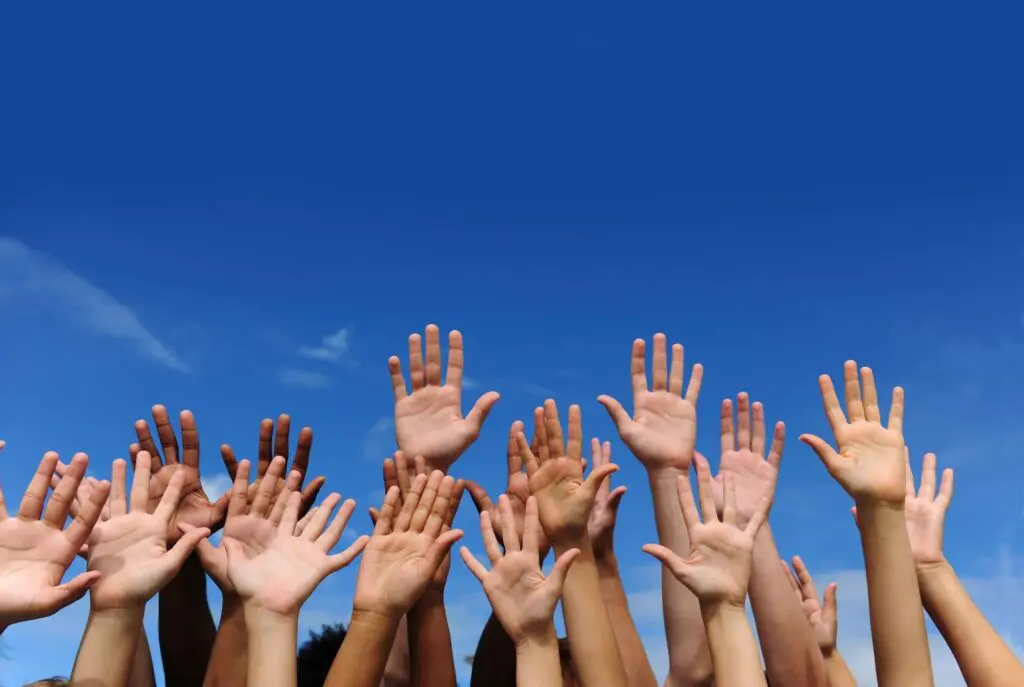 People raising their hands in the air People raising their hands in the air